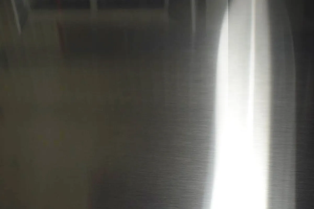 Close-up of directional No.4 snowflake finish on stainless steel sheet